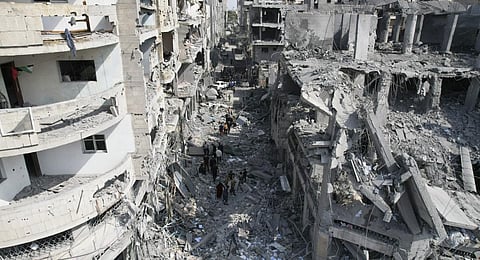 Palestinians look for survivors after the Israeli bombardment of the Gaza Strip in Deir Al-Balah, Sunday, Oct. 22, 2023.(Photo | AP)