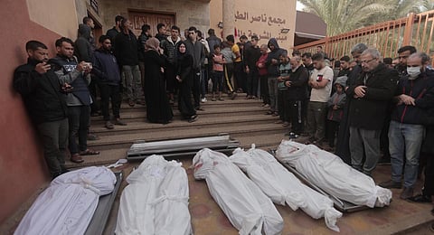 Palestinians pray for their relatives killed in the Israeli bombardment, at the Nasser hospital in Khan Younis, southern Gaza Strip, Sunday, Nov. 19, 2023. (AP Photo)