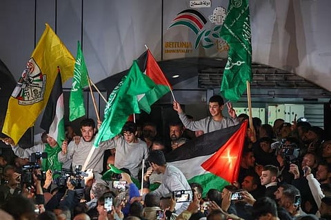 Palestinian prisoners cheer after being released from the Israeli Ofer military facility in the occupied West Bank in exchange for hostages freed by Hamas in Gaza, on November 24, 2023. (Photo | AFP)