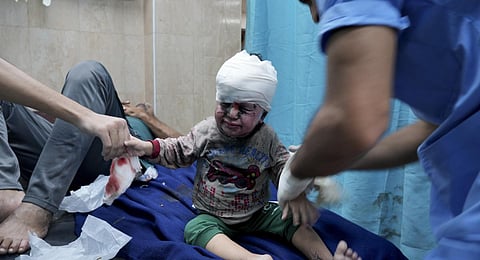 Palestinian child wounded in Israeli bombardment is treated in a hospital in Deir al Balah, south of the Gaza Strip. (Photo | AP)
