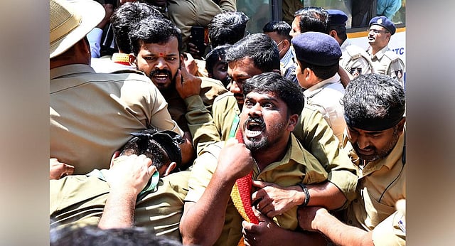 Autorickshaw drivers spar with police personnel, during a protest against the state government demanding a ban on whiteboard bike taxis, in Bengaluru on Monday | Shashidhar Byrappa