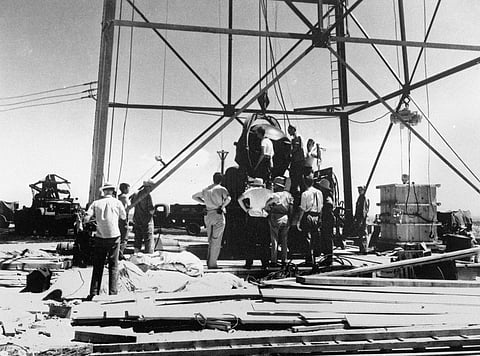 Scientists and other workers rig the world's first atomic bomb to raise it up onto a 100-foot tower at the Trinity Test Site near Alamagordo, New Mexico. (File Photo | AP)