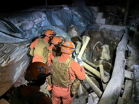 Rescuers search through a quake-affected area in Yamansu Township, Wushi County of Aksu prefecture, China's Xinjiang, Tuesday, January 23, 2024.