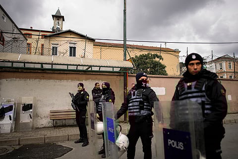 Turkish police officers stand guard in a cordoned off area outside the Santa Maria church, in Istanbul, Turkey, Sunday, Jan. 28, 2024.