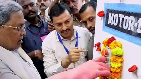 Karnataka CM tries to operate a switch at the launch of a lift irrigation project.