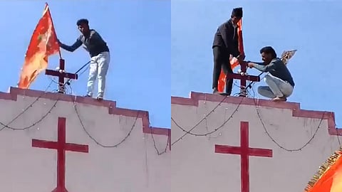In this screengrab two youngsters can been hoisting a saffron flag atop the house bearing Christian Cross in Jhabua, Madhya Pradesh, on Sunday.