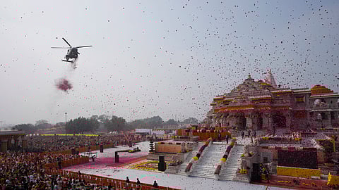 An Indian Air Force helicopter showers flower petals during the opening of a temple dedicated to Lord Ram in Ayodhya, Monday, Jan. 22, 2024.