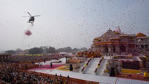 An Indian Air Force helicopter showers flower petals during the opening of a temple dedicated to Lord Ram in Ayodhya, Monday, Jan. 22, 2024.