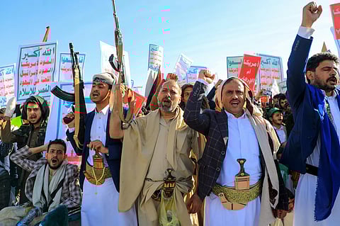 Supporters of Yemen's Huthis brandish rifles during a rally against Israel and the United States.