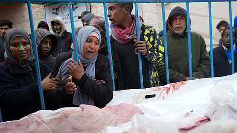 Palestinians mourn the relatives killed in the Israeli air and ground offensive on the Gaza Strip at a hospital in Deir al Balah.