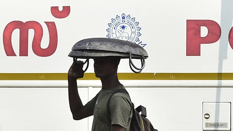 A migrant worker is using his iron tesla to escape from the heat of the scorching sun in Kochi on Sunday.