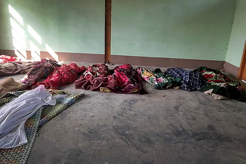 The bodies of the victims killed by airstrikes during the Myanmar conflicts are shrouded in blankets at a building in Kanan village, Khampat town in Sagaing region on Sunday, Jan.7, 2024.