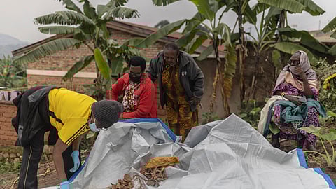 Women try to identify human remains of victims of the 1994 Rwandan Genocide found under the foundations of a house in Ngoma, Rwanda.