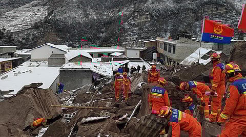 Rescue workers search the site of a landslide in Liangshui village, Tangfang Town in the city of Zhaotong, southwestern China's Yunnan Province.