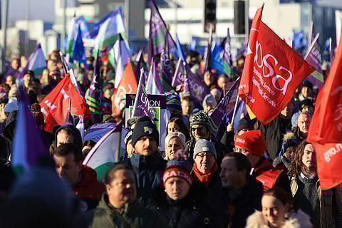 Public sector workers walk from the picket line at the Royal Victoria Hospital to a rally at Belfast City Hall, in Belfast, Thursday, Jan. 18, 2024