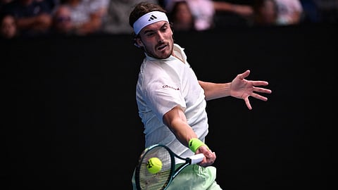 Greece's Stefanos Tsitsipas hits a return against France's Luca Van Assche during their men's singles match on day six of the Australian Open tennis tournament in Melbourne on January 19, 2024.