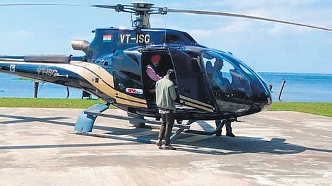 A helicopter with visitors lands on the helipad of the Kumarakom Lake Resort.