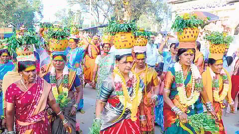 Women devotees are seen carrying Bonams on their heads to pay their offerings at the Mallikarjuna Swamy temple in Inavolu village in Hanamkonda district on Sunday
