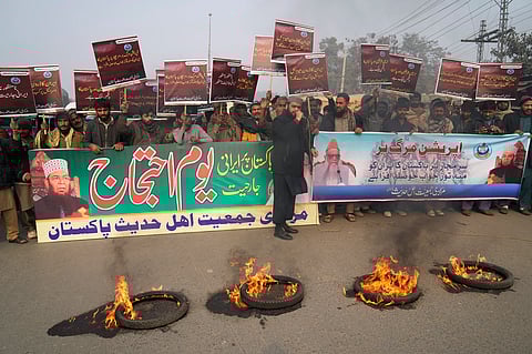 Supporters of a religious group 'Markazi Jamiyat Ahle Hadith Pakistan' burn tires and hold a demonstration to condemn Iran strike in the Pakistani border area, in Lahore, Pakistan, Friday, Jan. 19, 2024