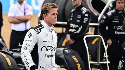 Actor Brad Pitt walks through the paddock before the British Formula One Grand Prix race at the Silverstone racetrack, Silverstone, England, Sunday, July 9, 2023.