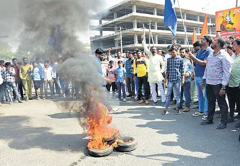 Agitators and Dalit activists burn tyres in protest over the desecration of a statue of Dr BR Ambedkar in Kalaburagi on Tuesday .