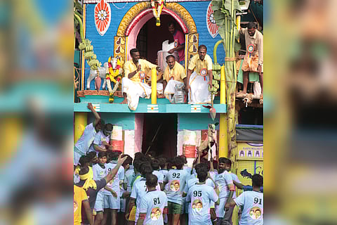 The organising committee give a goat prize to a bull tamer during the jallikattu in Palamedu near Madurai.