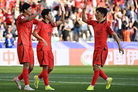 South Korea's midfielder #18 Lee Kang-in celebrates with teammates after scoring his team's third goal during the Qatar 2023 AFC Asian Cup Group E football match between South Korea and Bahrain at the Jassim bin Hamad Stadium in Doha on January 15, 2024.