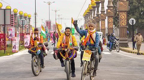 Devotees arrive on cycles ahead of the consecration ceremony of Ram Mandir, in Ayodhya.