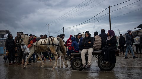 Palestinians displaced by the Israeli air and ground offensive on the Gaza Strip ride on a cart in Rafah, Saturday, Jan. 27, 2024.
