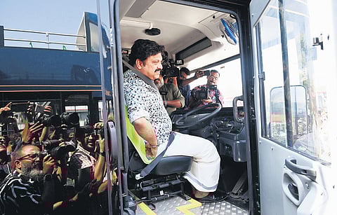 Transport Minister K B Ganesh Kumar behind the wheels of an electric double-decker bus of the KSRTC before a
test drive in Thiruvananthapuram.