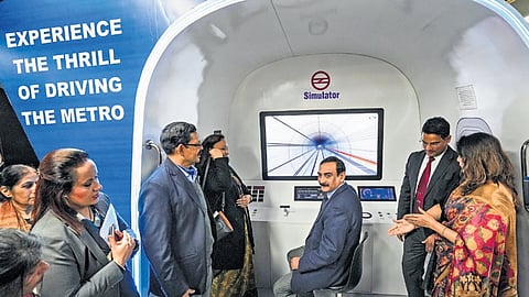 DMRC MD Vikas Kumar inspects a metro train simulator during the inauguration of ‘Interactive Museum Exhibits’ at Shivaji Park Metro Station on Wednesday.
