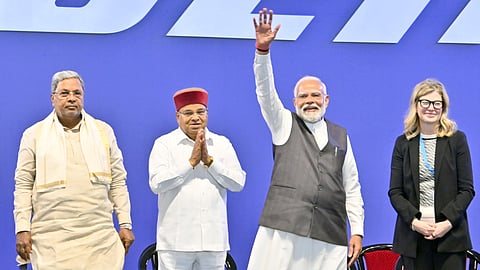 Prime Minister Narendra Modi waves to the gathering, while Boeing COO Stephanie Pope looks on, in Bengaluru.