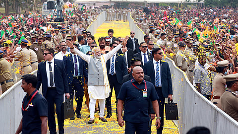 Prime Minister Narendra Modi greets supporters during his visit to Thrissur, Kerala.
