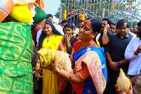 Endowments Minister Konda Surekha seeks blessing for a child at Sammakka-Saralamma altar in Medaram on Wednesday