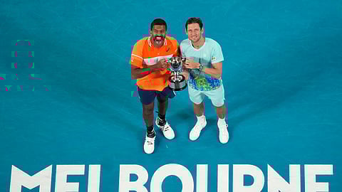 Rohan Bopanna, left, of India and Matthew Ebden of Australia pose with their trophy after defeating Simone Bolelli and Andrea Vavassori of Italy in the men's doubles final Australian Open tennis championships at Melbourne, Australia.