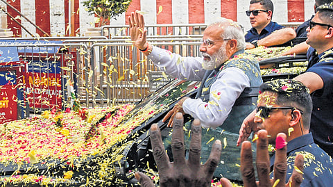 Prime Minister Narendra Modi receives floral reception from caders, during his visit to Sri RanganathaSwamy Temple in Srirangam, Tiruchy on Saturday.