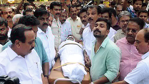 Congress workers with the body of Chakkittapara resident V Joseph, who killed himself allegedly due to disability pension dues, at Kozhikode collectorate on Jan 24, 2024.