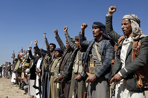 Houthi fighters and tribesmen stage a rally against the U.S. and the U.K. strikes on Houthi-run military sites near Sanaa, Yemen, on Sunday, Jan. 14, 2024.