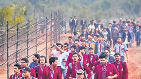 Students walk to a temporary deer enclosure during the night trail.