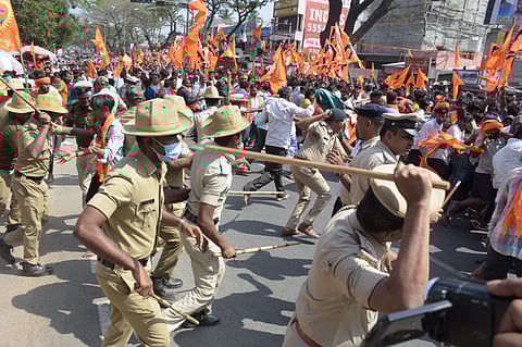 Police resort to lathi charge against agitators during the procession who tried to damge flex and boards of MLA Ravi Ganiga in Mandya on Monday.