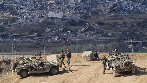Israeli soldiers take up positions near the Gaza Strip border, in southern Israel, Friday, Dec. 29, 2023.