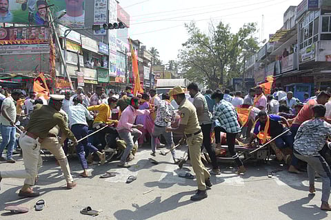 Police resort to lathi charge against agitators during the procession who tried to damge flex and boards of MLA Ravi Ganiga in Mandya on Monday.