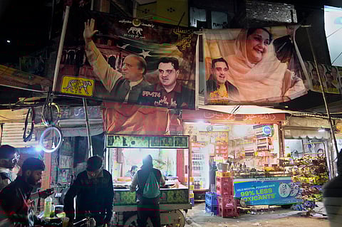 Election campaign poster of Pakistan's former Prime Minister Nawaz Sharif's party are displayed at a market in Lahore, Pakistan, Feb. 5, 2024.