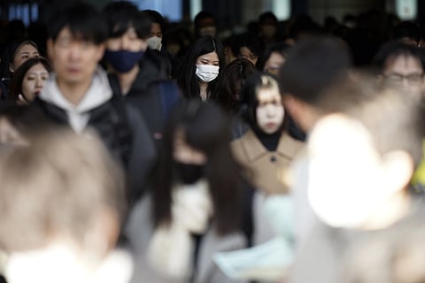 Commuters walk in passageway during a rush hour at Shinagawa station, Wednesday, Feb 14, 2024.