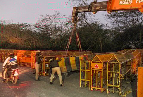 Police personnel stand guard during traffic restrictions at the Shambhu Border ahead of the scheduled march by the protesting farmers towards Delhi.