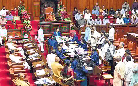BJP members protest in the well of the Council over Social Welfare Department’s decision to replace the wording of Rashtrakavi Kuvempu at the entrance of classrooms in its schools