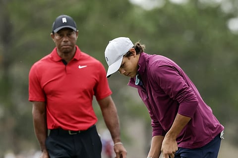 FILE -Tiger Woods, left, watches his son Charlie, right, putt ball during the final round of the PNC Championship golf tournament Sunday, Dec. 17, 2023, in Orlando, Fla.