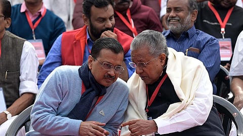 Delhi Chief Minister Arvind Kejriwal interacts with Kerala Chief Minister Pinarayi Vijayan during LDF's protest against the BJP-led Centre over alleged neglect and partiality in allocation of funds to their states, at Jantar Mantar, in New Delhi, on Feb. 8, 2024.
