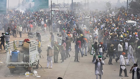 Police use tear gas to disperse farmers gathered at the Punjab-Haryana Shambhu border during their 'Delhi Chalo' march, in Patiala district, Tuesday, Feb. 13, 2024.