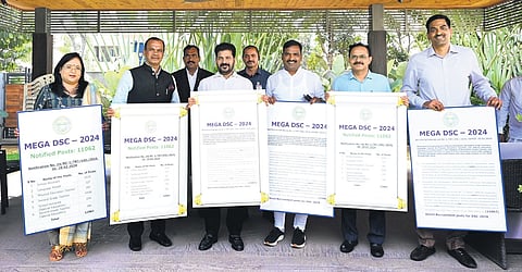 Flanked by Telangana Education department officials, Chief Minister A Revanth Reddy releases the Mega DSC notification in Hyderabad on Thursday